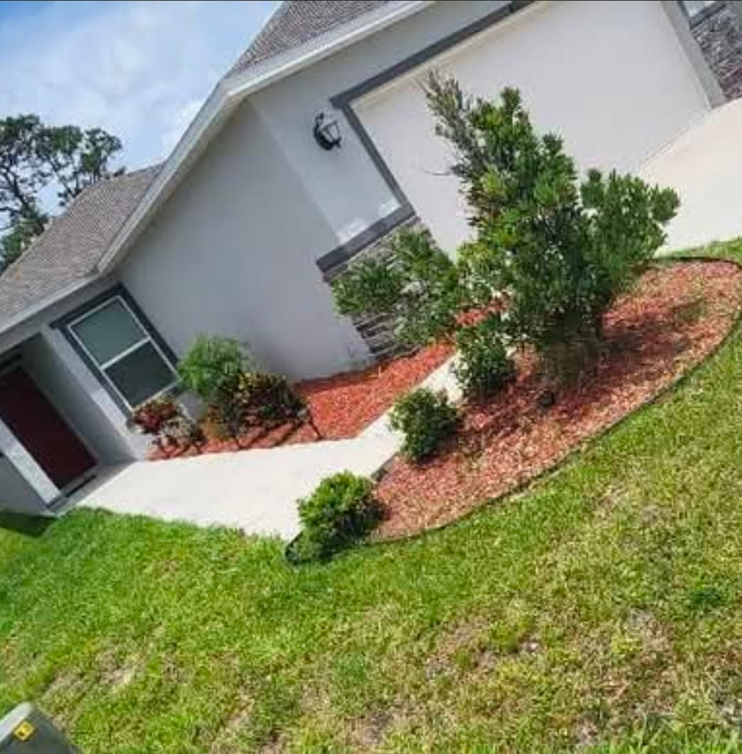 Before — plain mulch landscaping bed beside house